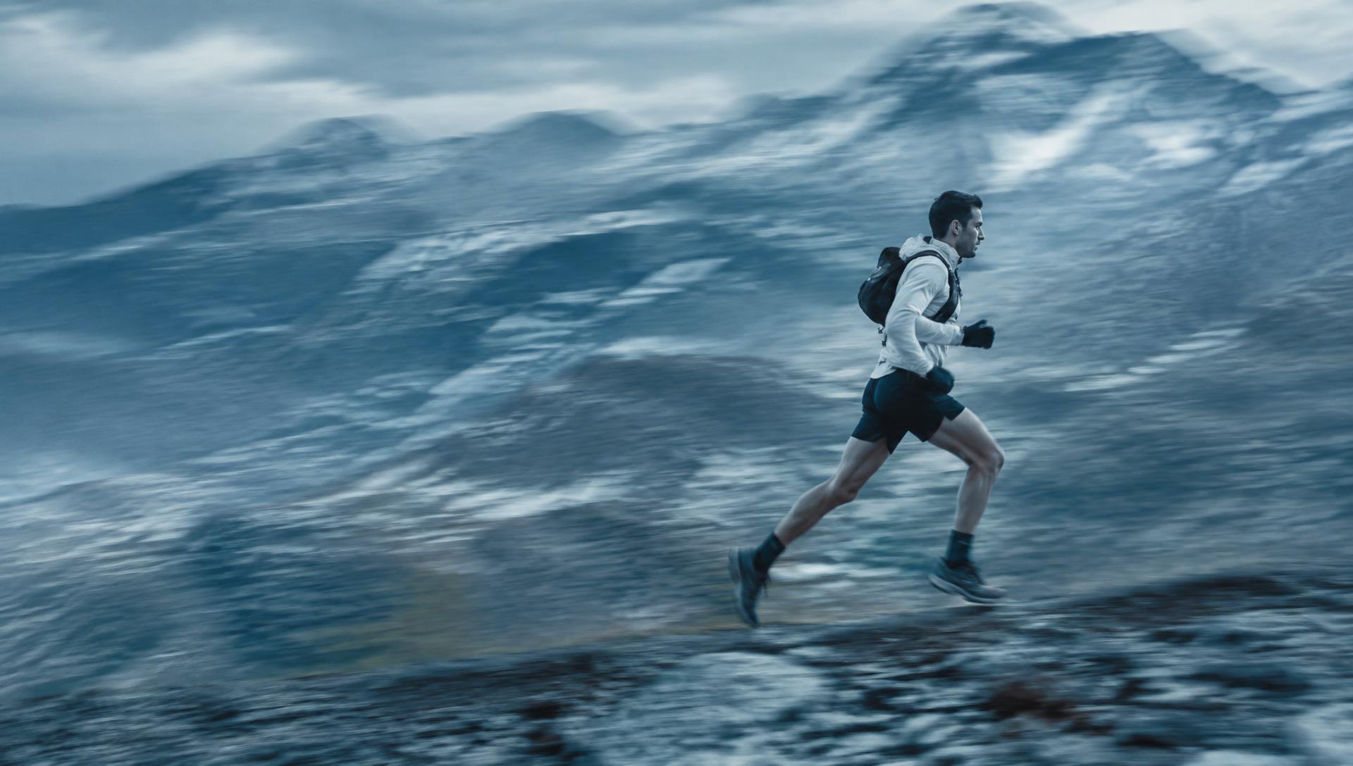 Trail runner moving across a mountain ridge
